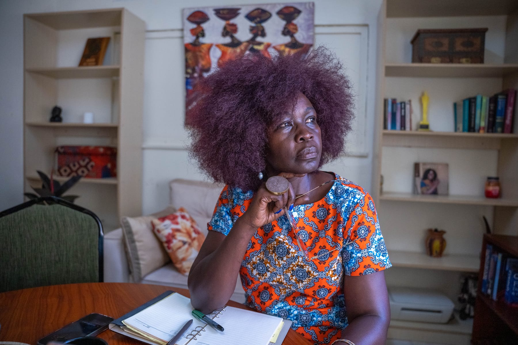 Ashanut Okille at her desk, journaling